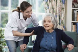 nurse helping an elderly woman